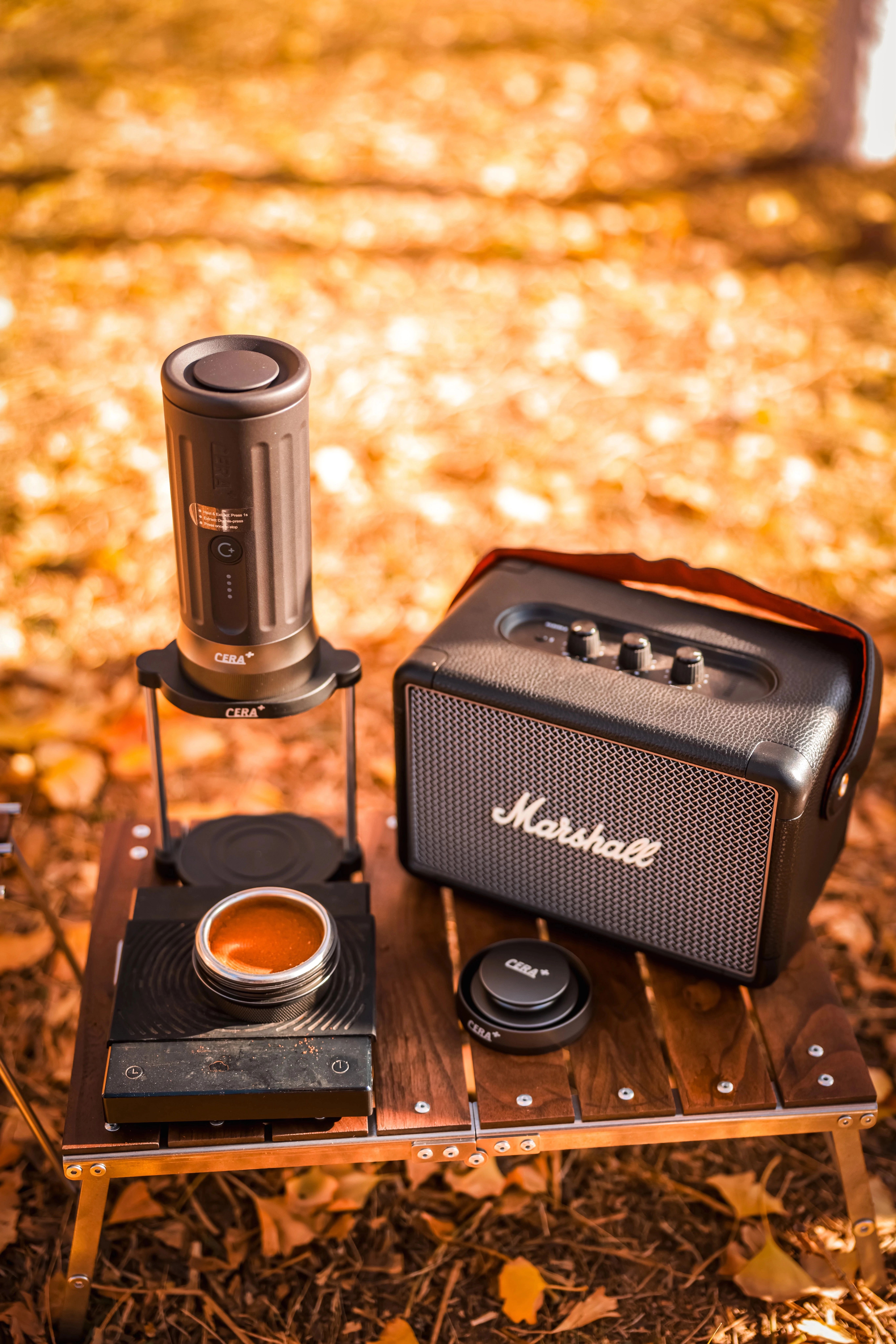 CERA+ PCM03S-MAX beside a portable speaker and travel case